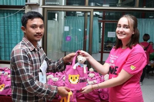 Iryna Danevich (right) gives out gift bags to the parents of cleft patients